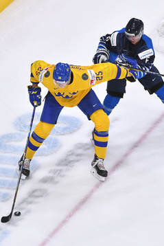 Elmer Söderblom of Sweden uses his body to protect the