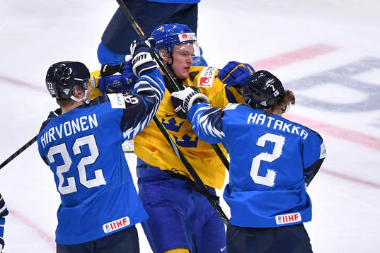 Oskar Kvist of Sweden battles with Santeri Hatakka and Roni