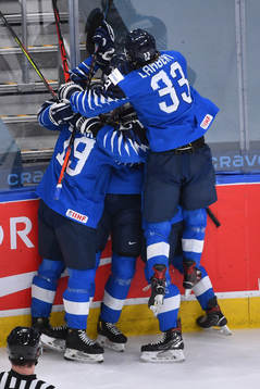 Henri Nikkanen of Finland celebrates with teammates Petteri