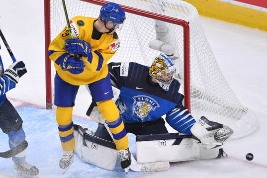Kari Piiroinen of Finland makes a save with Emil Heineman