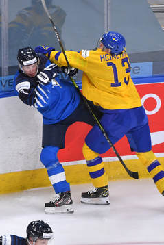 Emil Heineman of Sweden hits Topi Niemela of Finland into