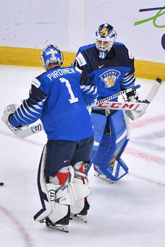 Roope Taponen and Kari Piiroinen of Finland exchange