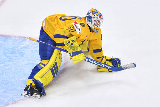 Jesper Wallstedt of Sweden smothers the puck
