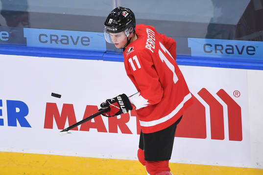 Cole Perfetti of Canada bounces the puck off this stick