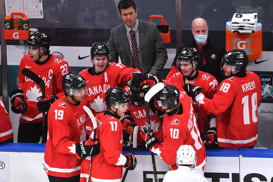Alex Newhook of Canada is congratulated by teammates