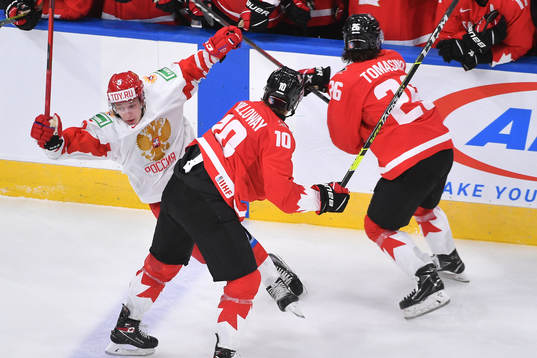 Philip Tomasino of Canada collides with Danil Chaika of