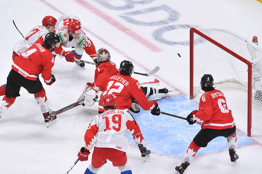 Marat Khusnutdinov of Russia shoots the puck wide of the