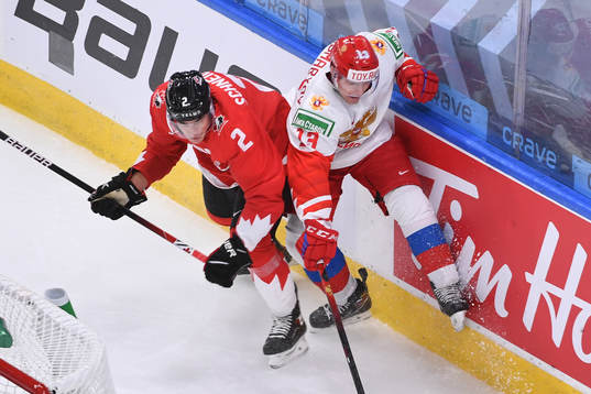 Braden Schneider of Canada collides with Vasili Ponomaryov