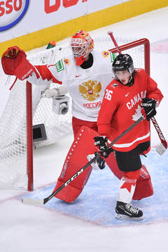 Philip Tomasino of Canada gets his skate caught in the pad