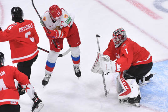 Devon Levi of Canada makes a save