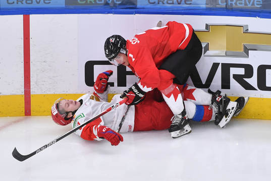 Braden Schneider of Canada checks Mikhail Abramov of Russia