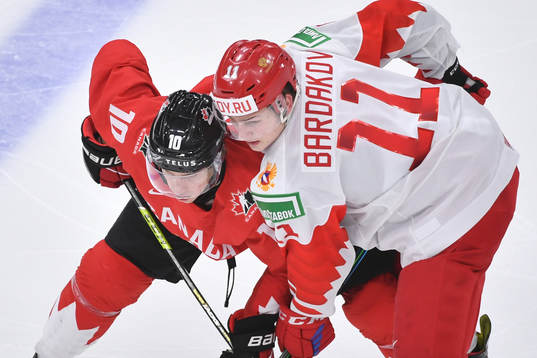 Dylan Holloway of Canada battles Zakhar Bardakov of Russia
