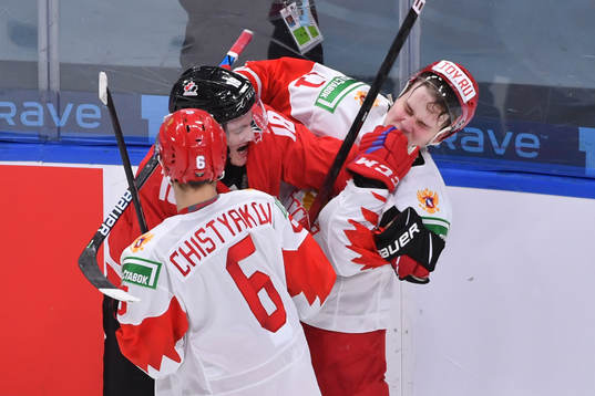 Peyton Krebs of Canada scrums with Zakhar Bardakov of Russia