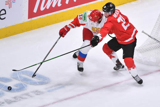 Vasili Podkolzin of Russia fends off Dawson Mercer of Canada