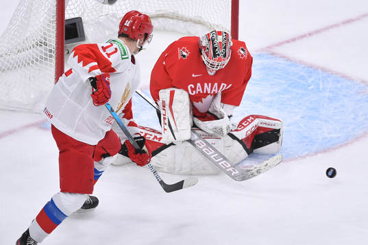 Devon Levi of Canada makes a save