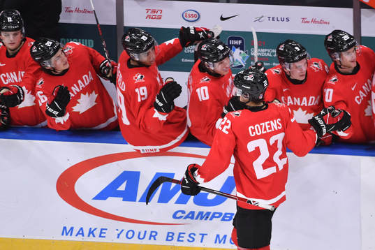 Dylan Cozens of Canada celebrates at the bench