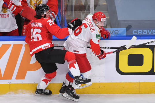 Philip Tomasino of Canada collides with Semyon Chistyakov