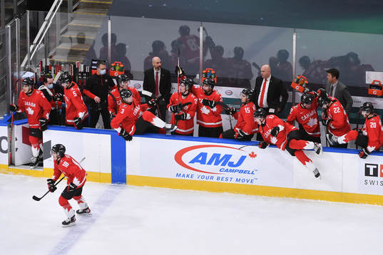 Team Canada jumps off the bench to celebrate their 5-0