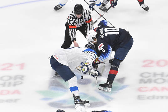 Matthew Beniers of USA and Anton Lundell of Finland face off