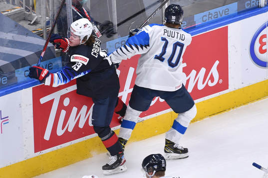 Kasper Puutio of Finland collides with Cole Caufield of USA