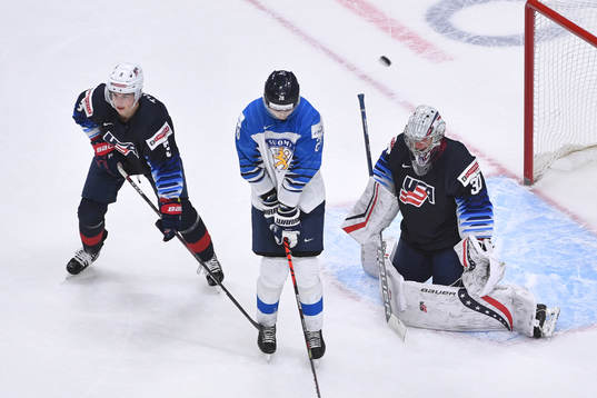 Henri Nikkanen of Finland deflects the puck in front of the