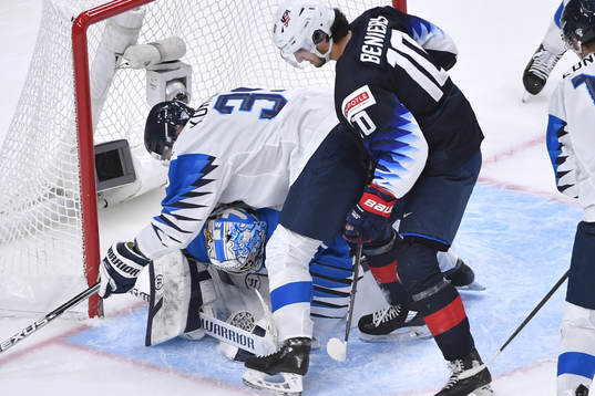 Kari Piiroinen of Finland smothers the puck as teammate