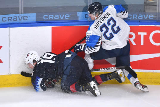 Roni Hirvonen of Finland collides against the boards with