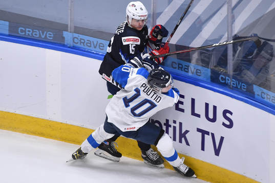 Kasper Puutio of Finland collides with Alex Turcotte of USA