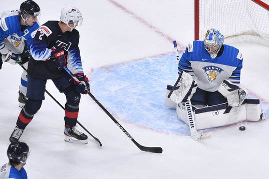 Kari Piiroinen of Finland makes a save with Matthew Boldy