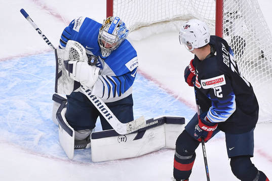 Kari Piiroinen of Finland makes a save with Matthew Boldy
