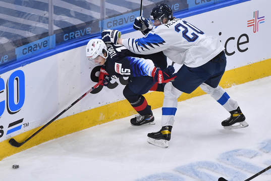 Samuel Helenius of Finland collides with Alex Turcotte of