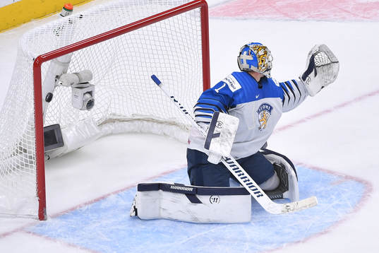 Kari Piiroinen of Finland can not stop the puck as it