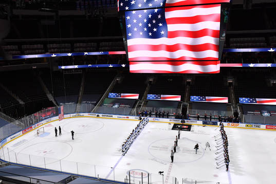 Team Finland and Team USA stand for the playing of the USA