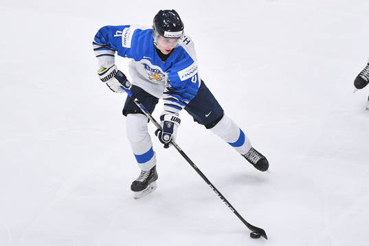 Ville Heinola of Finland skates with the puck