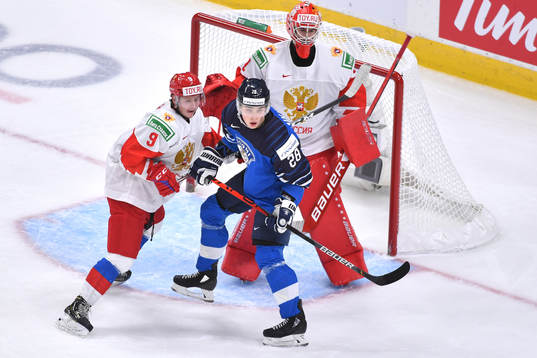 Henri Nikkanen of Finland battles for position with Mikhail