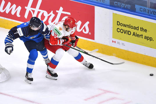 Vasili Podkolzin of Russia uses his body to fend off Topi