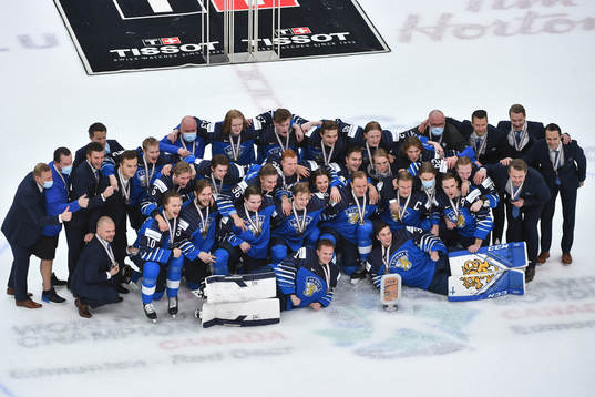 Team Finland poses for a photograph with their medals