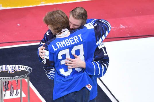 Team captain Anton Lundell of Finland hugs teammate Brad