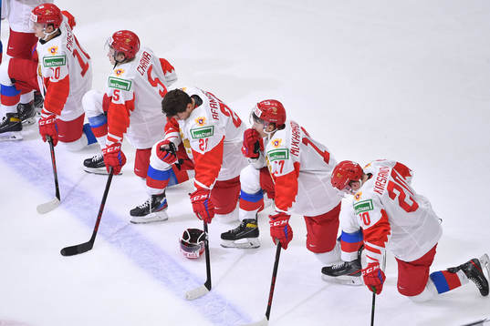 Team Russia players watch as Team Finland celebrates their