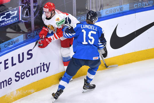 Anton Lundell of Finland collides with Danil Chaika of