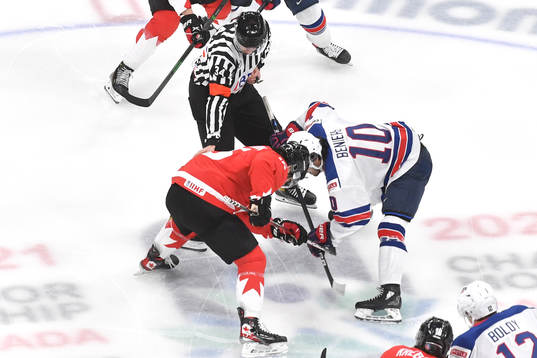 Alex Newhook of Canada takes the opening face-off against