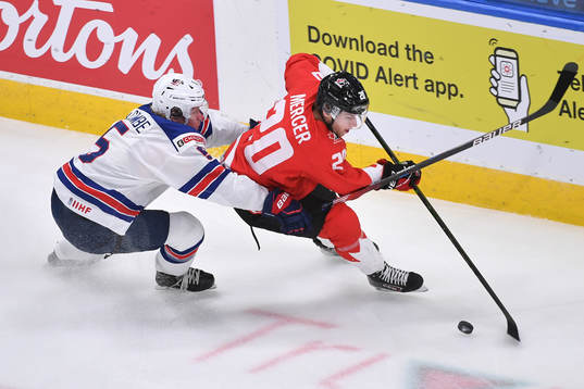 Dawson Mercer of Canada protects the puck from Jackson