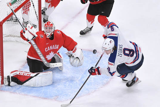 Devon Levi of Canada makes a save