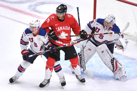 Quinton Byfield of Canada battles in front of the net with
