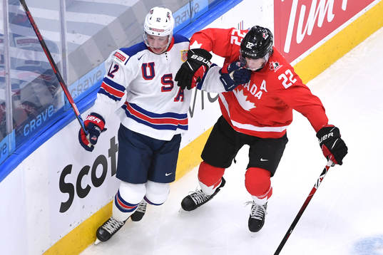 Dylan Cozens of Canada and Matthew Boldy of USA battle for