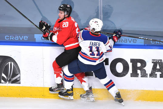 Brock Faber of USA takes Dawson Mercer of Canada into the