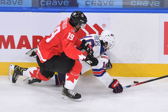 Quinton Byfield of Canada knocks Matthew Beniers of USA to