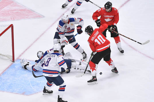 Dylan Holloway and Quinton Byfield of Canada  battle in