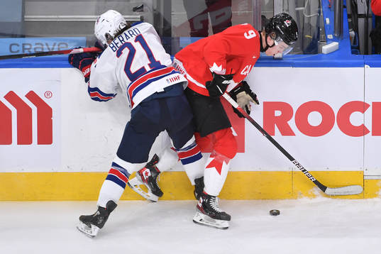 Brett Berard of USA collides with Connor Zary of Canada