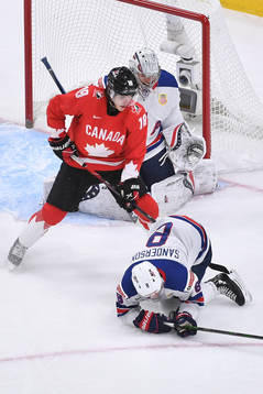Jake Sanderson of USA covers the puck